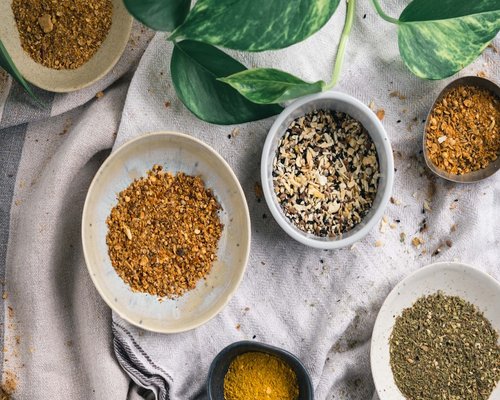 A collection of ceramic dishes filled with natural wholesome spices on a table